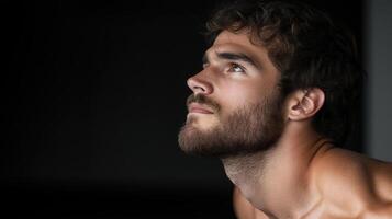 Athletic man with beard looking up, showcasing determination and focus photo