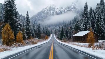 foggy mountain road leads to remote village surrounded by snow covered trees photo