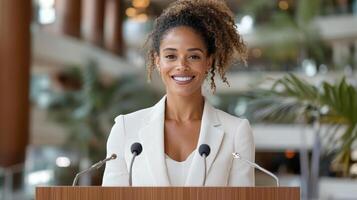 confident woman standing at podium in modern setting, smiling warmly photo