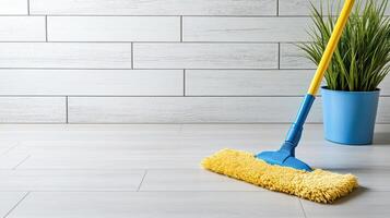 close up of mop cleaning shiny floor with plant nearby photo