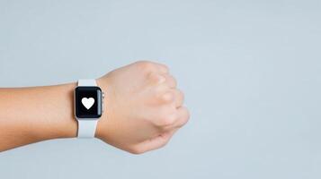 smartwatch displaying heart symbol on user wrist, promoting health awareness photo