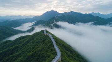 Aerial view of Great Wall of China amidst lush mountains and clouds photo