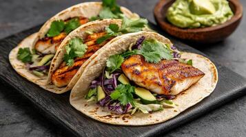 Delicious fish tacos with grilled cod, cabbage slaw, and fresh cilantro photo