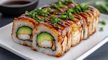 Delicious homemade dragon roll sushi topped with avocado and sauce photo