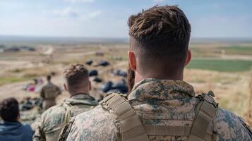 soldier observing landscape, reflecting on their mission and surroundings photo