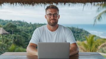 man working on laptop in tropical setting, enjoying view photo