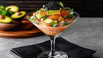 Ceviche served in martini glass topped with avocado and caviar, delightful dish photo