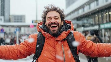Happy man winter coat enjoying snowfall outdoors with arms wide open, expressing joy and photo