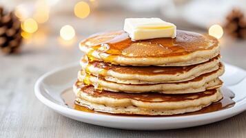 Fluffy buttermilk pancakes stacked high, drizzled with syrup, and topped with butter photo