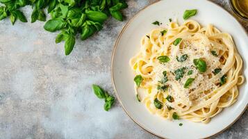 Creamy pasta dish garnished with fresh basil leaves, perfect for cozy meal photo
