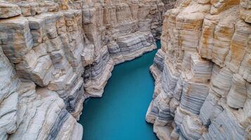 breathtaking aerial view of dramatic canyon with layered rock formations and turquoise river photo