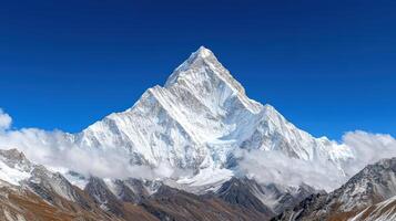 Majestic mountain peak covered in snow under clear blue sky, evoking awe and tranquility photo