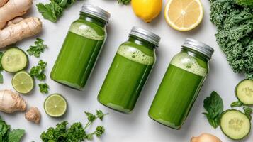 Fresh green juice in jars surrounded by vegetables and fruits photo