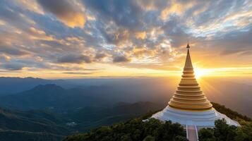 stunning golden pagoda rises majestically against vibrant sunset sky, surrounded by mountains photo