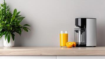 Fresh juice on minimalist kitchen counter with modern juicer and vibrant oranges photo