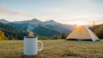 serene camping scene featuring steaming mug foreground, with tent and mountains background photo