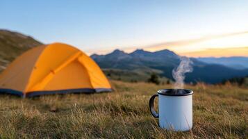serene camping scene featuring steaming mug of coffee foreground, with vibrant orange tent set photo