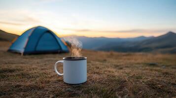 serene camping scene featuring steaming cup of coffee foreground, with tent and mountains photo
