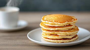 Fluffy pancakes stacked plate, accompanied by warm cup of coffee, create cozy breakfast scene photo