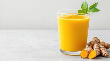 vibrant glass of golden turmeric drink with fresh turmeric roots beside it, showcasing health photo