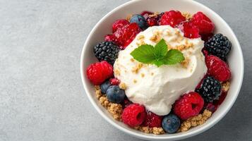 Delicious dessert bowl filled with mixed berries, whipped cream, and crunchy crumbs photo