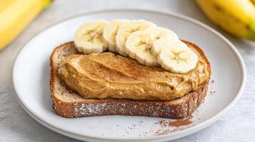 Creamy cashew butter spread whole grain toast topped with banana slices, creating delicious photo