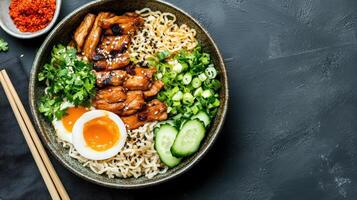 Delicious ramen bowl featuring tender chicken, fresh vegetables, and soft boiled egg photo
