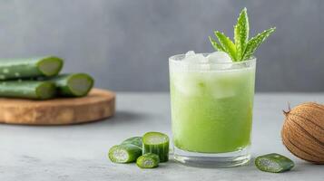 Refreshing aloe vera and coconut detox juice with ice and garnished with aloe leaves photo