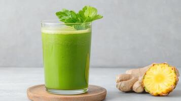 Refreshing green juice with wheatgrass and pineapple, garnished with mint leaves photo