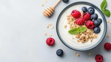 vibrant bowl of yogurt topped with fresh berries, granola, and honey creates delightful photo