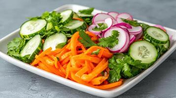 Fresh vegetable platter with carrots, cucumbers, and radishes, garnished with cilantro photo