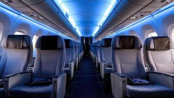modern airplane cabin with blue ambient lighting, featuring empty seats and spacious aisle photo