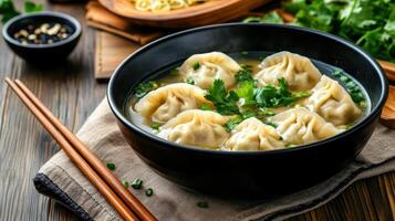 Delicious dumpling soup served in bowl, garnished with fresh herbs, evokes warmth and comfort photo