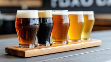 Craft beer tasting with flight of various styles in glasses on wooden tray photo