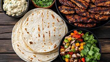 Delicious grilled meat served with tortillas, fresh salsa, and dips photo