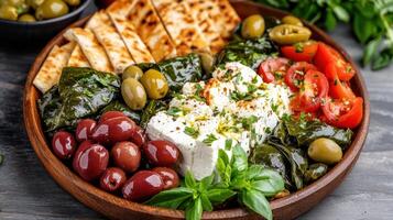 vibrant Mediterranean vegetarian platter featuring olives, tomatoes, and feta cheese photo