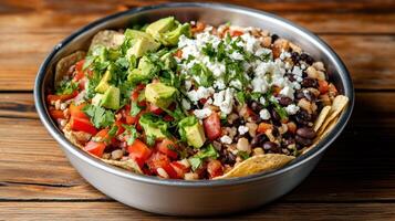 vibrant vegetarian nacho platter featuring black beans, fresh avocado, and colorful toppings photo