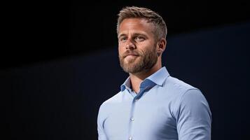 Professional man with beard wearing light blue shirt, exuding confidence and focus photo