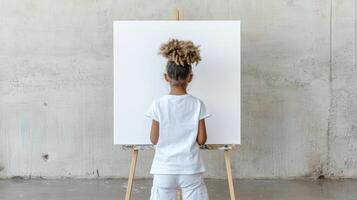 child stands in front of blank canvas, ready to unleash creativity and imagination photo