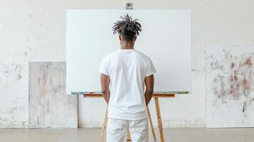 student stands before blank canvas, ready to unleash creativity and inspiration photo