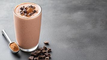 Creamy chocolate protein shake topped with cocoa powder and chocolate chips, perfect for boost photo