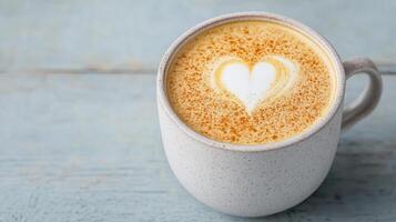 creamy golden latte with heart design top, served textured white mug, evokes warmth and comfort photo