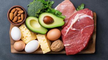 Fresh meat, eggs, cheese, and vegetables arranged on wooden board for healthy meal photo