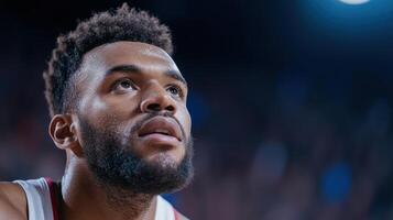 focused basketball player gazes upward, contemplating game ahead, showcasing determination and photo