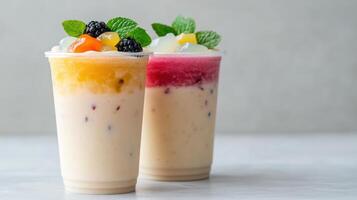 Refreshing dessert drinks topped with fruits and mint leaves, perfect for warm day photo