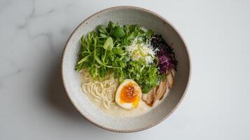 Creamy ramen bowl with fresh herbs, soft boiled egg, and tender chicken slices photo