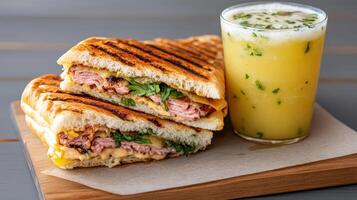delicious Cuban sandwich with layers of meat and fresh herbs, paired with refreshing drink photo