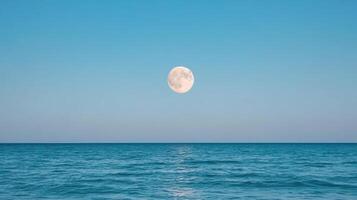 serene full moon rises over calm ocean, creating tranquil atmosphere photo