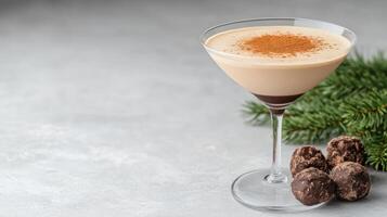 Creamy espresso martini garnished with cocoa powder, paired with chocolate truffles and festive photo