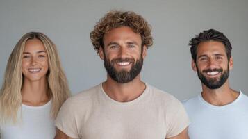 Smiling group of three people with diverse hairstyles and casual clothing, showcasing happiness photo